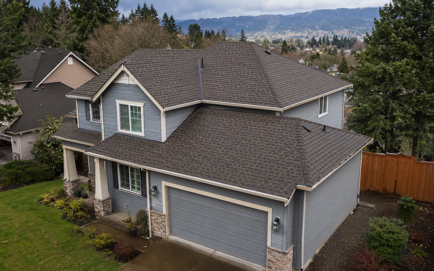 Completed roof on a two-story gray home