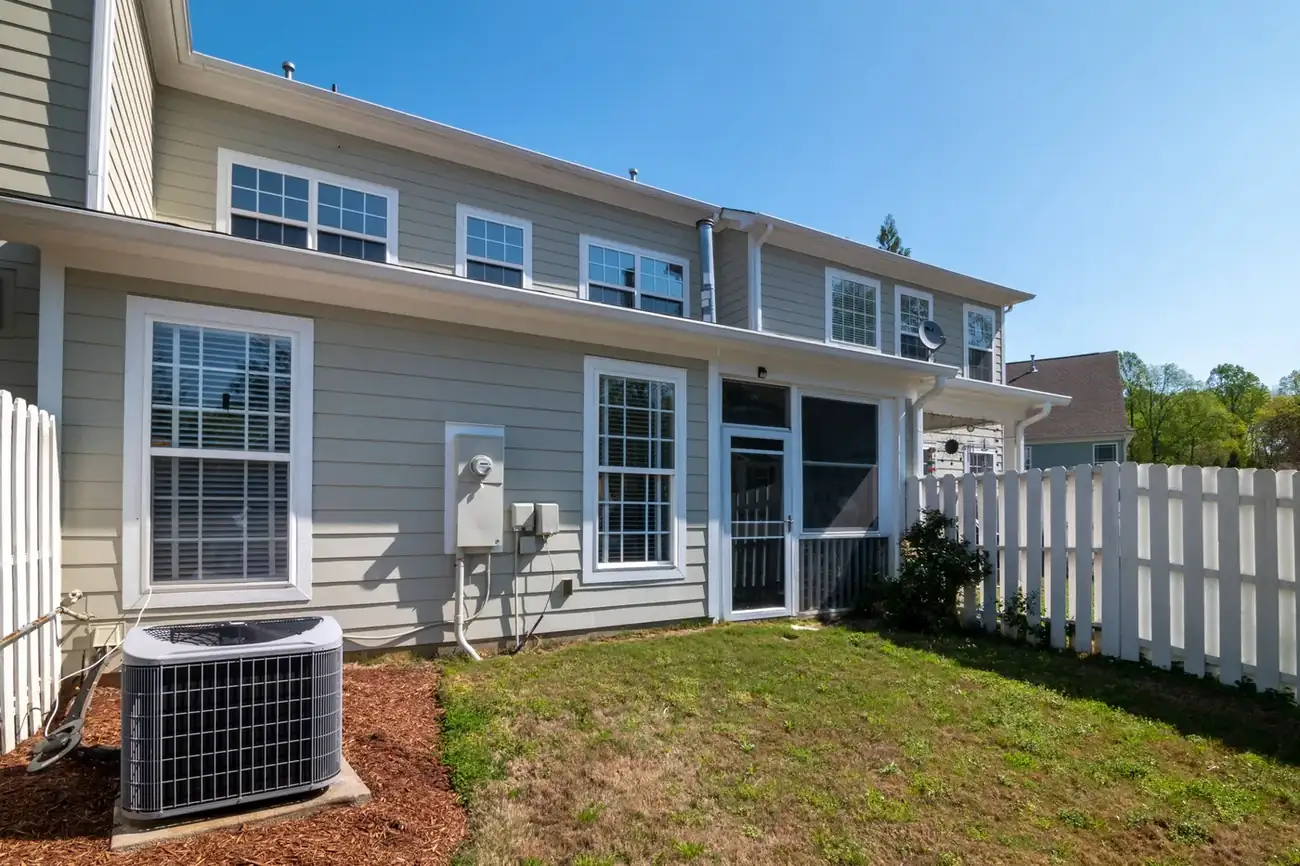 Gray-sided residential home with integrated window and corner trim