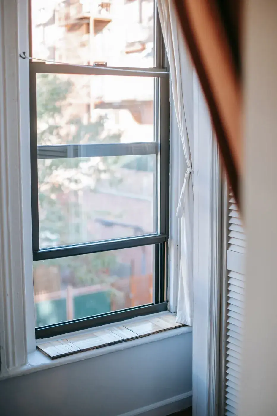 Double-hung residential window with finished trim and natural daylight